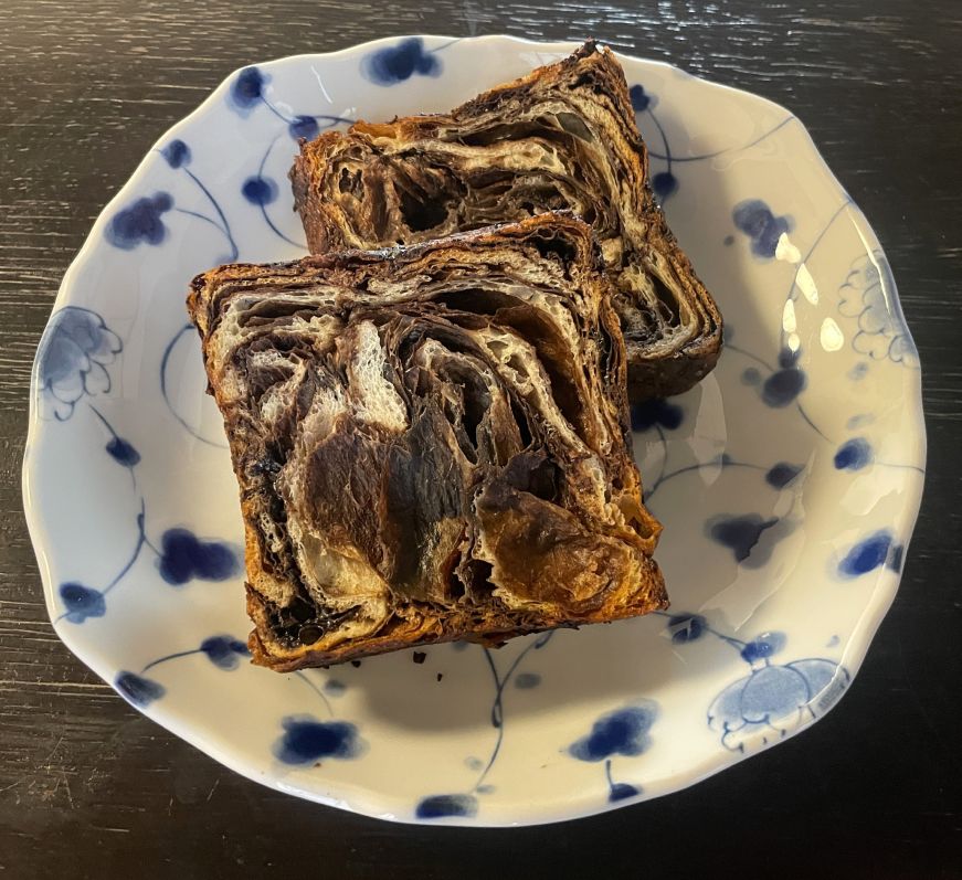 Two slices of chocolate swirled bread on a plate
