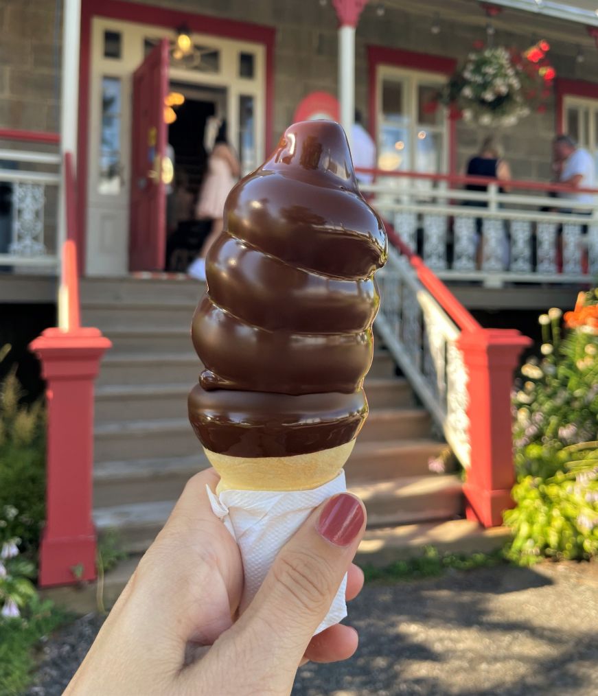 Stacy's hand holding a chocolate dipped cone