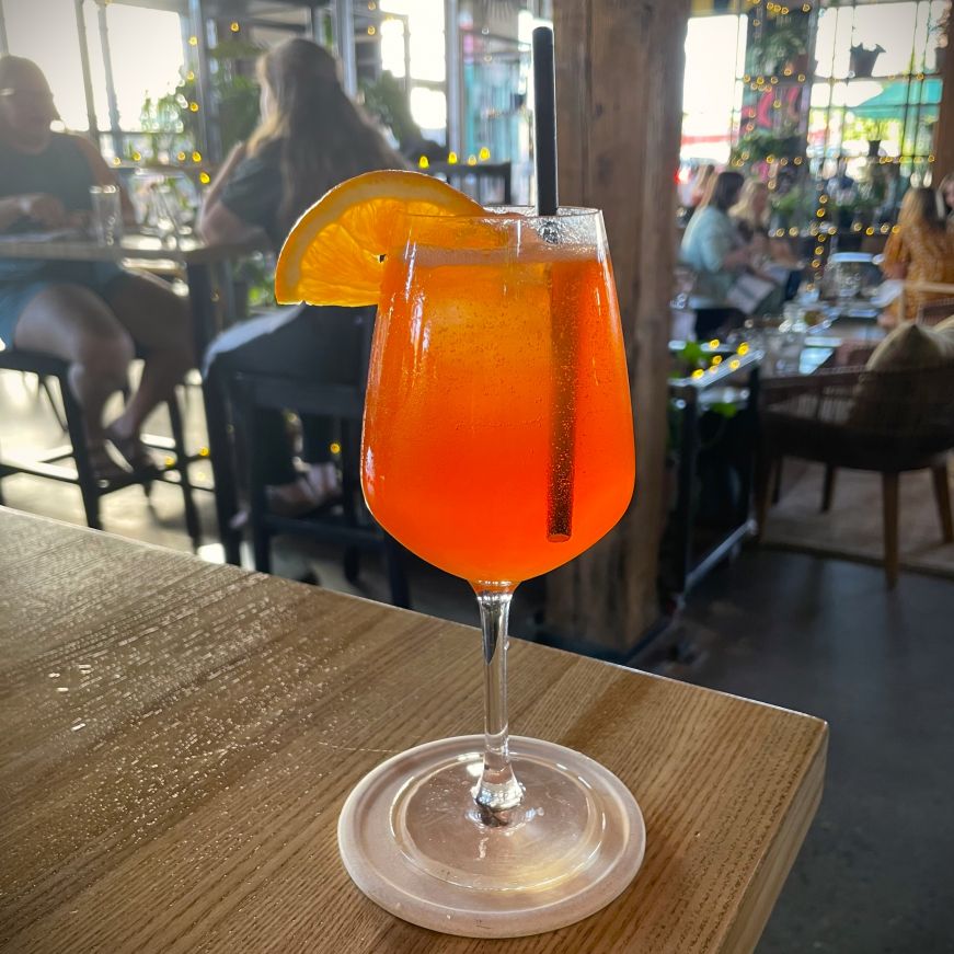 Bright red cocktail in a stemmed wine glass