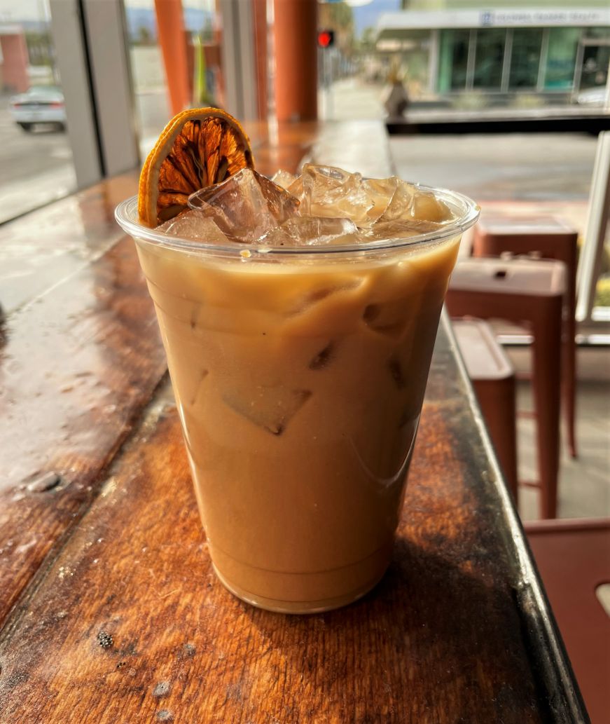 Iced coffee garnished with a dried lemon slice