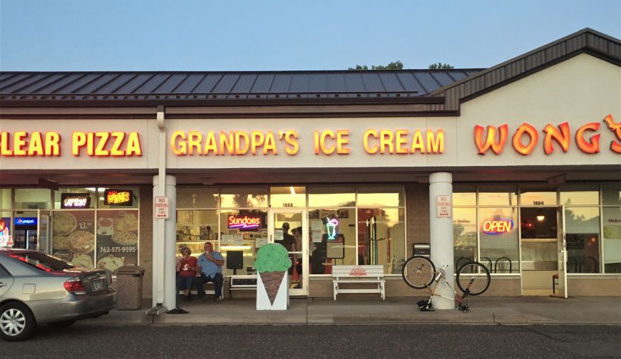 Strip mall storefront with sign reading "Grandpa's Ice Cream"