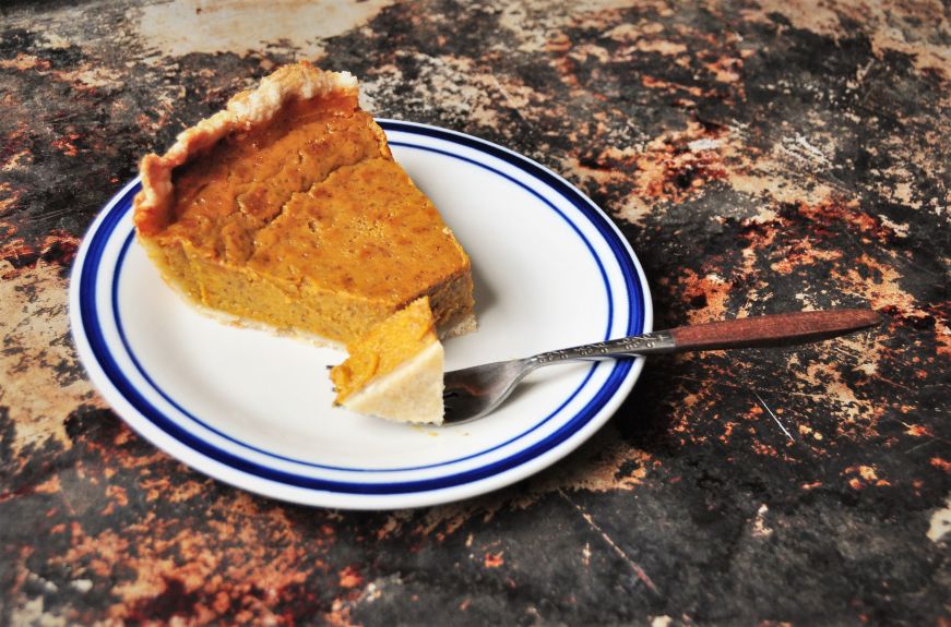 Festal Golden Pumpkin Pie slice with bite