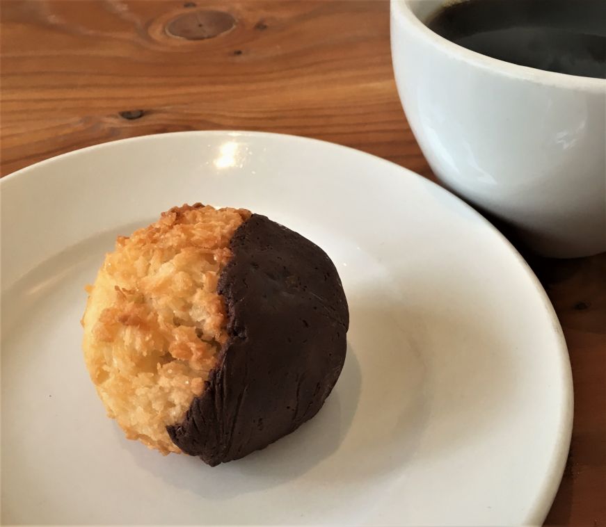 Chocolate dipped coconut macaroon on a plate with a cup of coffee in the background, Fireroast Coffee & Wine Bar, Minneapolis Chocolate dipped coconut macaroon on a plate with a cup of coffee in the background, Fireroast Coffee & Wine Bar, Minneapolis