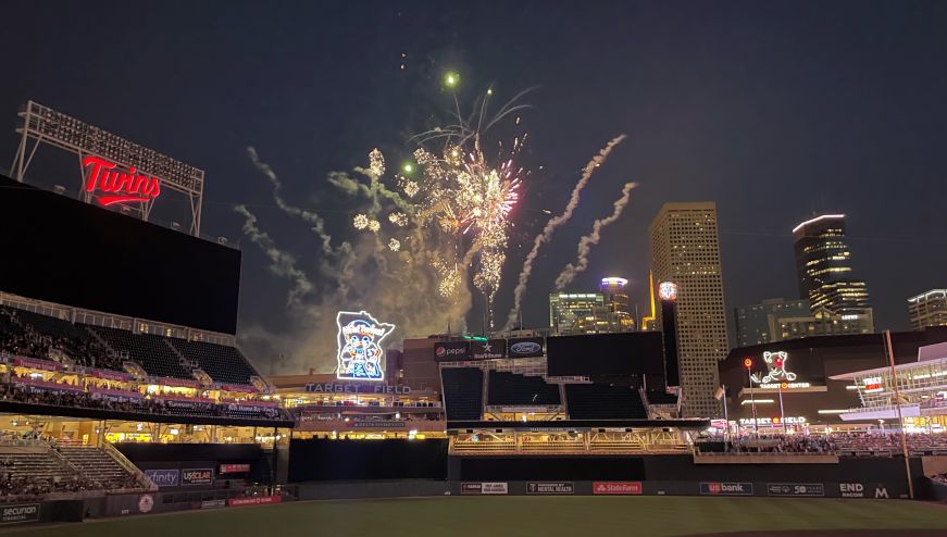 Fireworks exploding over a baseball stadium