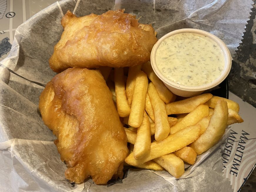 Fish and chips, Reykjavik Fish Restaurant Basket with two pieces of fried fish, fries, and cup of tartar sauce