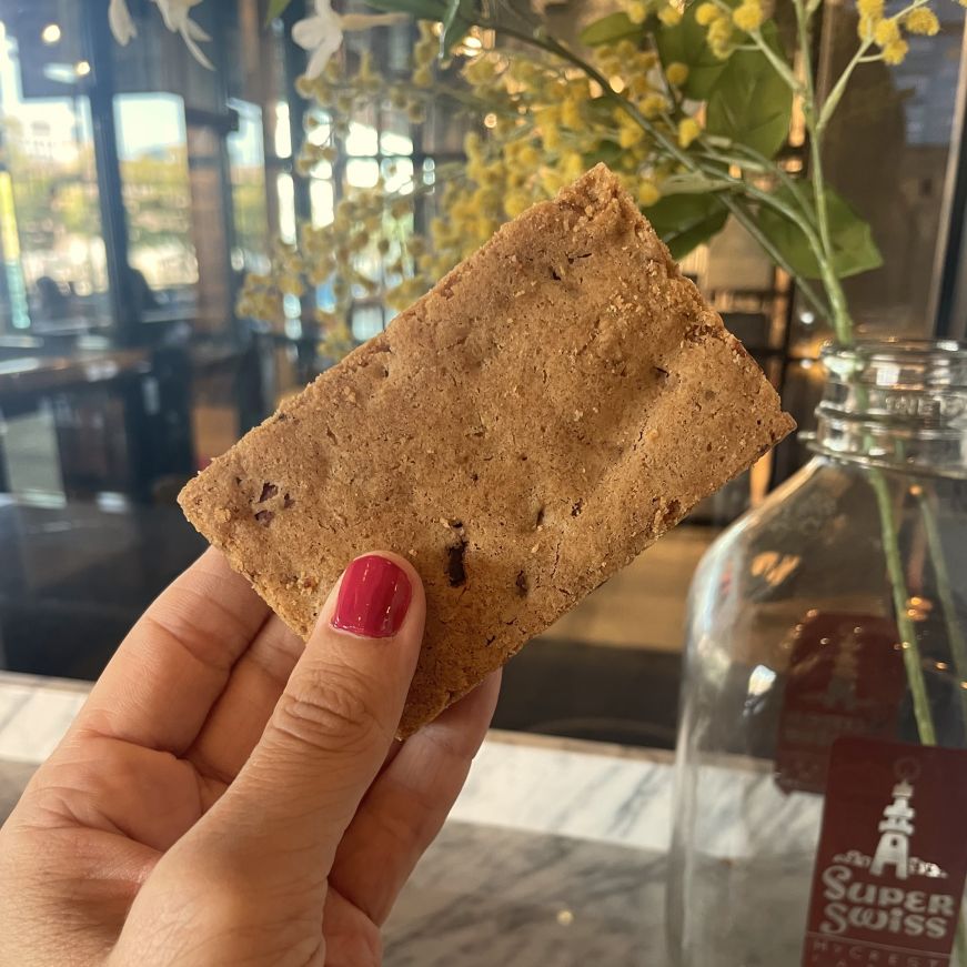 Brown butter pecan blondie, Flour Bakery Stacy's hand holding a bar cookie