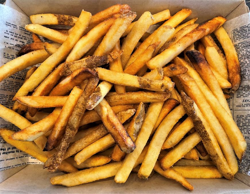 Takeout box filled with fries