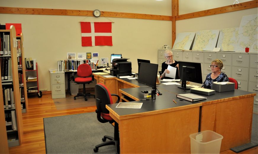 Women sitting desks researching at Genealogy Center, Museum of Danish America, Elk Horn, Iowa