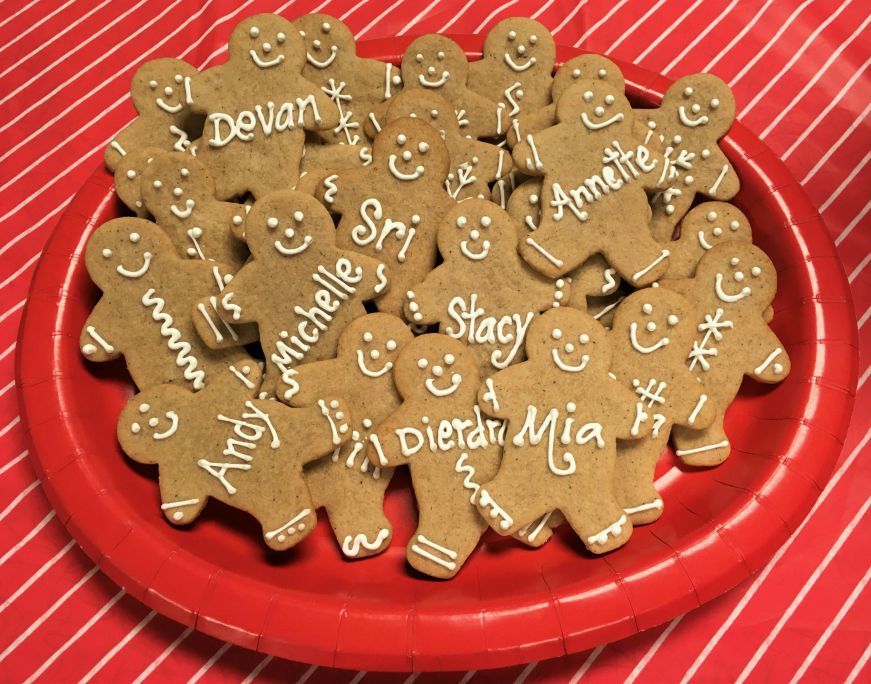Plate of gingerbread men with names written on them with icing