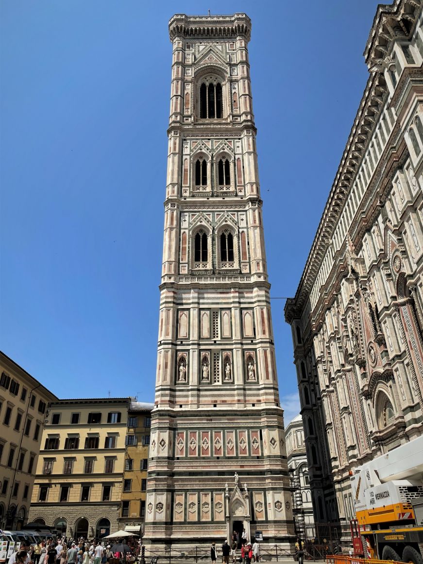 Very tall freestanding bell tower with an ornate white exterior
