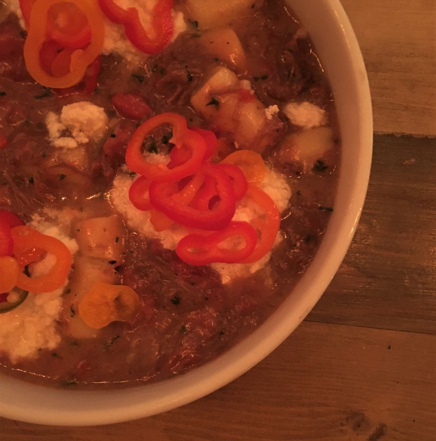 Bowl of gnocchi with stew of short ribs and tomatoes garnished with dollops of ricotta and pepper slices, Rooster & the Till, Tampa