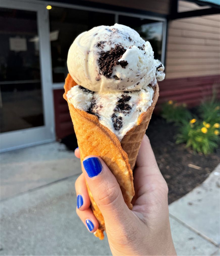 Black Hills Gold in a waffle cone, Grand Ole Creamery Stacy's hand holding a waffle cone