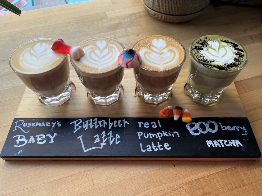 Coffee flight garnished with Halloween gummies and candy corn