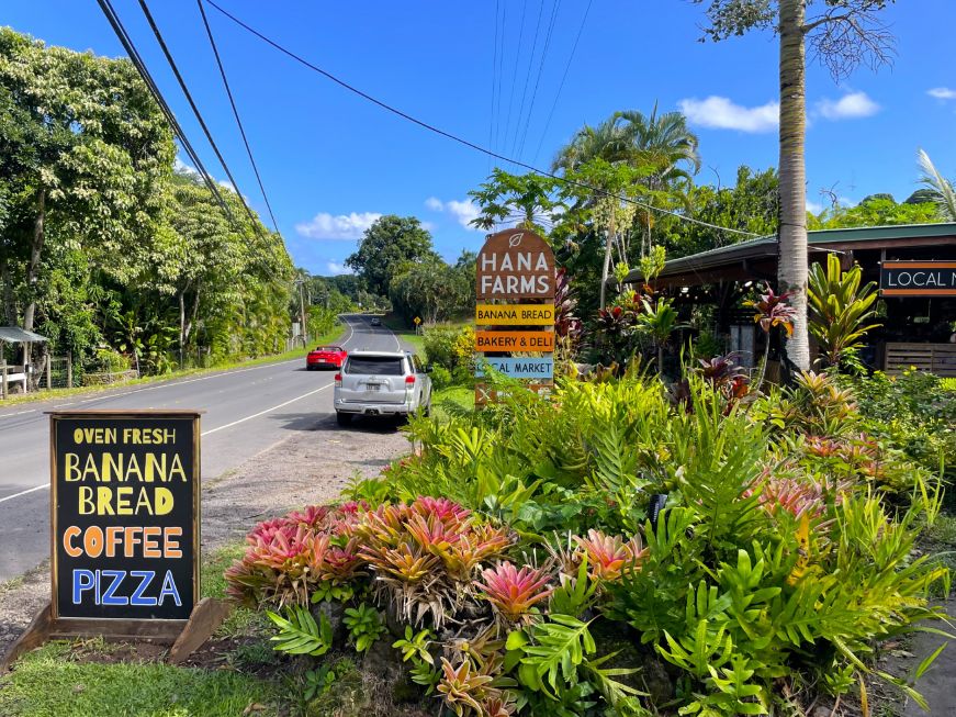 Signs for Hana Farms alongside road
