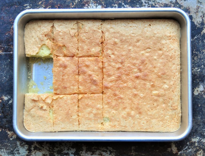Hawaiian butter mochi in a rectangular pan with one slice removed