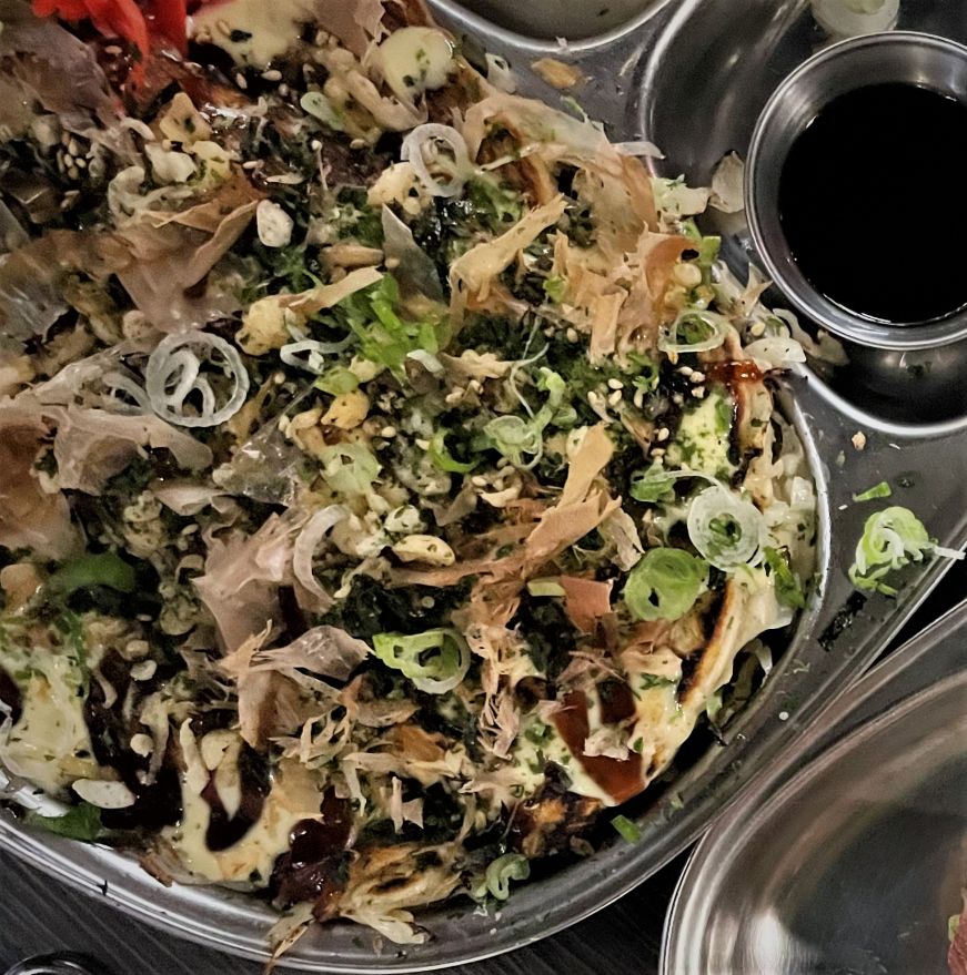Hiroshima Okonomiyaki, PinKU Japanese Street Food Pancake loaded with cabbage, bonito, and tempura flakes