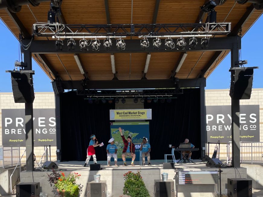 Stage with actors performing a game show while dressed as Minnesota's state symbols