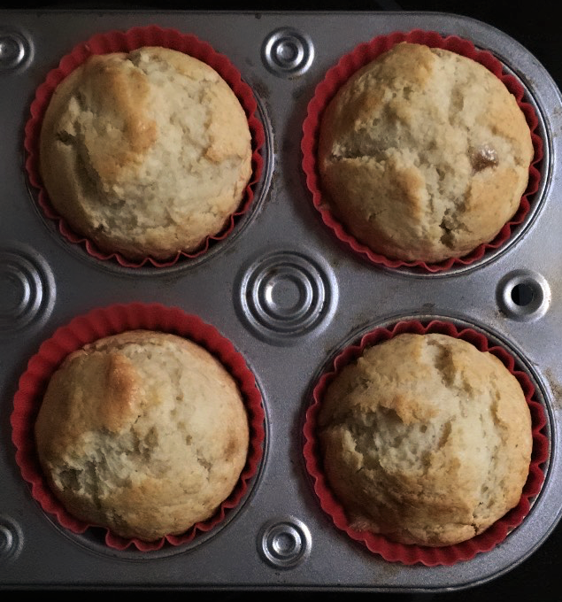 Four honey muffins in a muffin tin