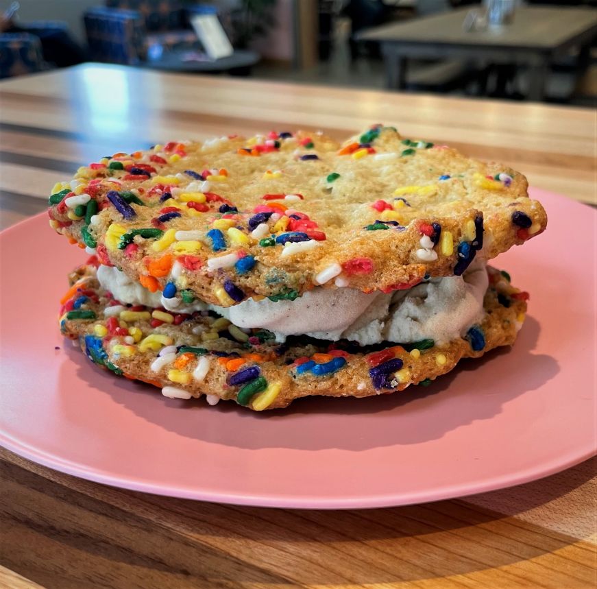 Ice cream sandwich made from cookies with rainbow sprinkles