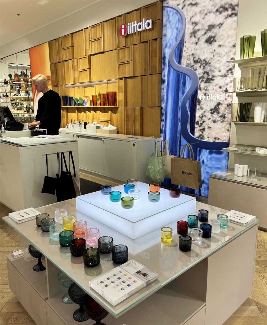 Iitaala store in Helsinki Store interior with a display of colorful glass candleholders