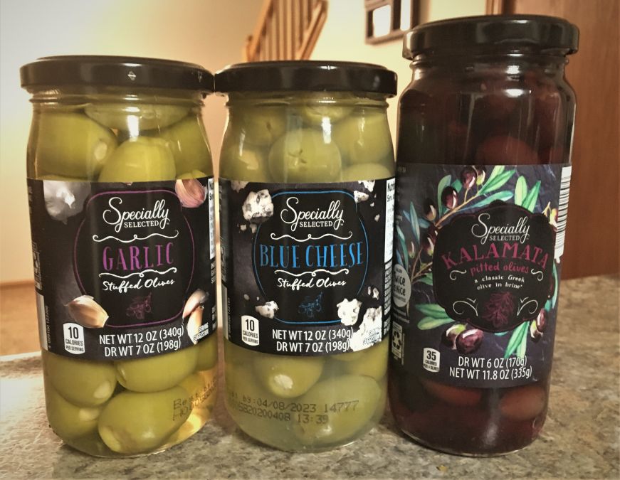 Garlic, blue cheese, and kalamata olives, Aldi Three jars of olives on countertop