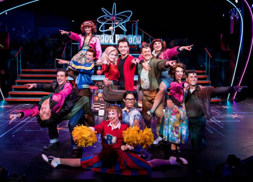 Grease at Chanhassen Dinner Theatres Cast of the musical Grease on stage singing the final song