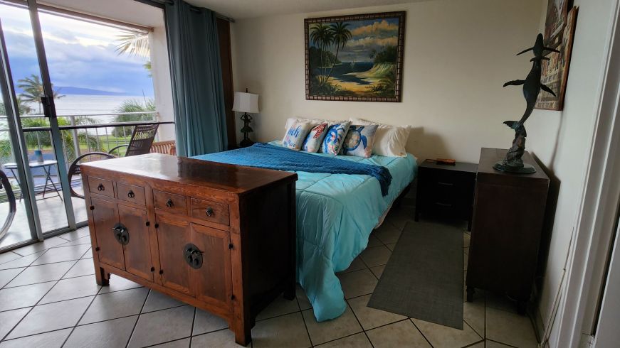 Bedroom at our Kihei ocean view condo Bedroom with beach decor with a view of the ocean through the window