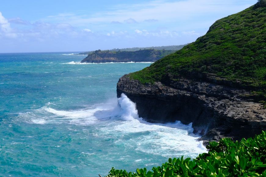 Massive wave crashing into a rocky cliff