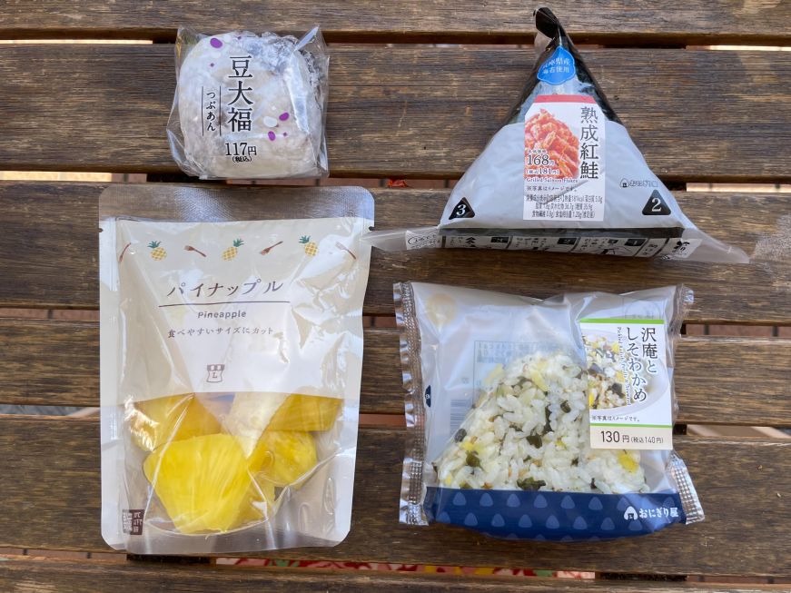 Onigiri, fruit and mochi from Lawson Plastic wrapped onigiri, mochi, and package of cut pineapple