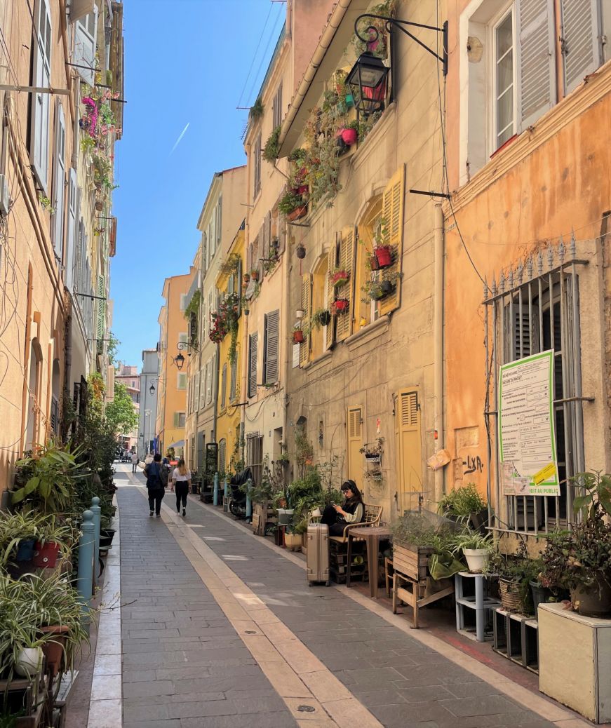 Narrow street with flowers in window boxes