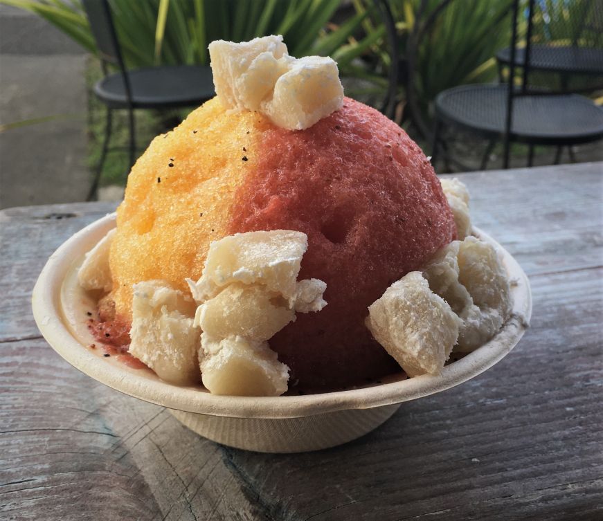 Cup of yellow and pink shave ice topped with cubes of mochi, Kula Shave Ice