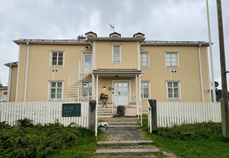 Two story pastel yellow wooden building