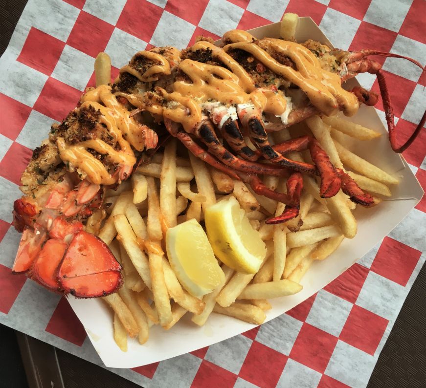 Lobster & fries, La Pistola Fries topped with a half lobster in the shell drizzled with white sauce