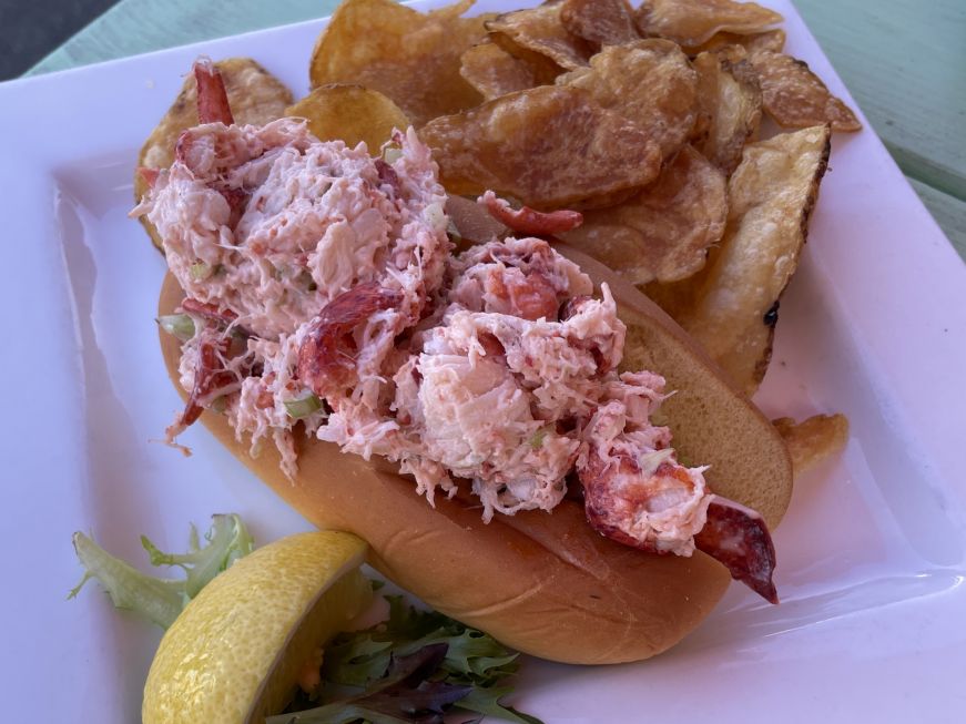 Lobster roll on a plate with kettle chips