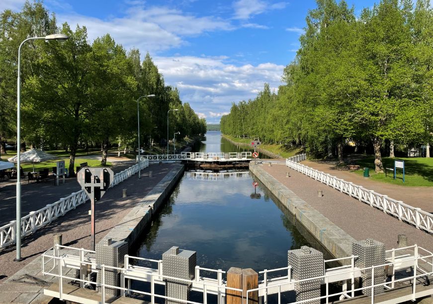 Canal with a lock and trees on each side