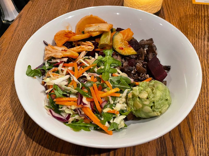 Macro Bowl at Chanhassen Dinner Theatres Bowl of whole grains topped with beets, kimchi, mushrooms, slaw, and a scoop of guacamole