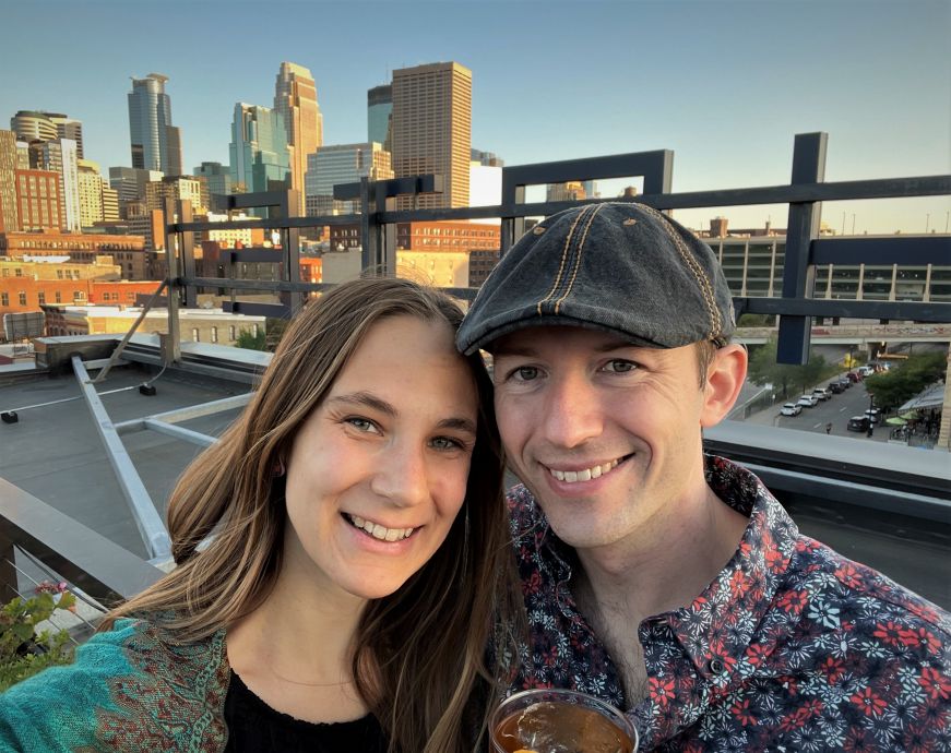 Stacy and Mike at rooftop bar with the Minneapolis skyline in the background