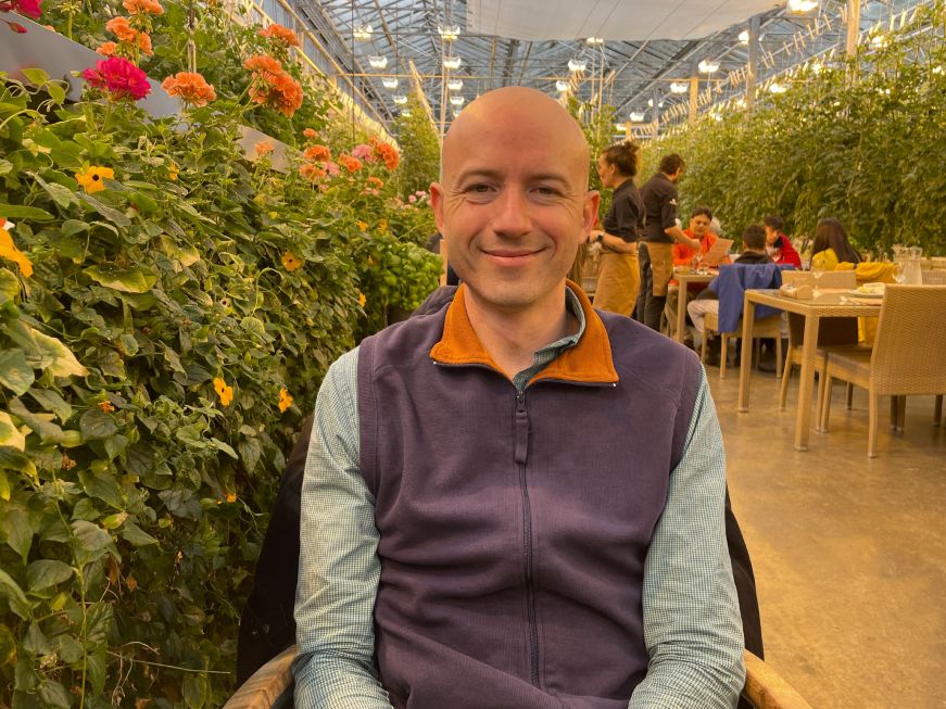 Mike in the greenhouse dining room at Friðheimar