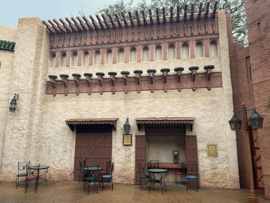 Facade modeled on a Moroccan building with bistro tables