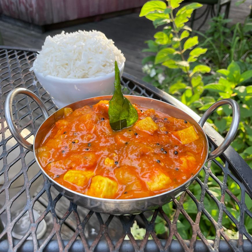 Tangy mango curry, Namaste Cafe, Minneapolis Bowl of tofu mango curry with rice on the side