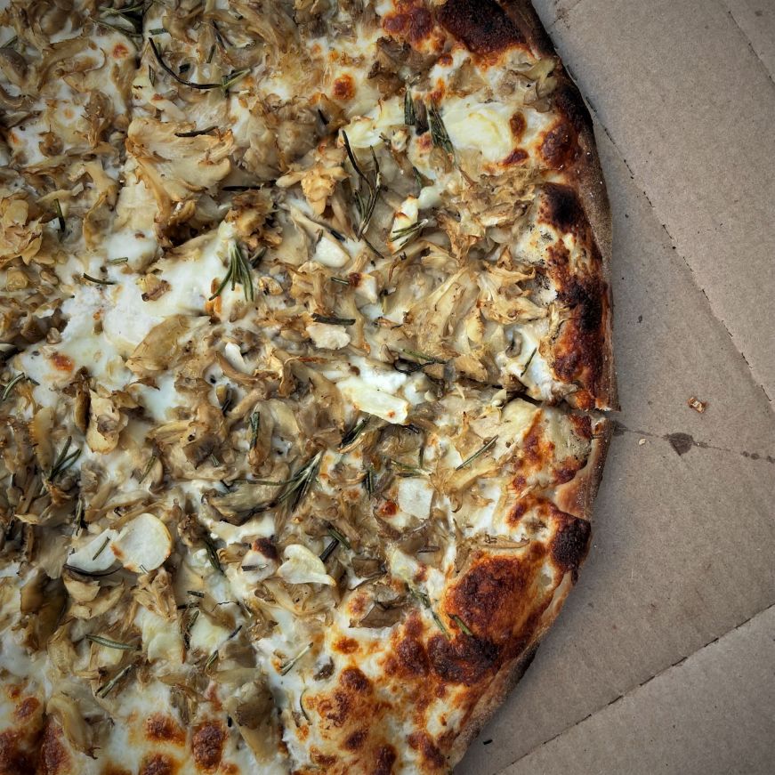 Pizza topped with oyster mushrooms and rosemary