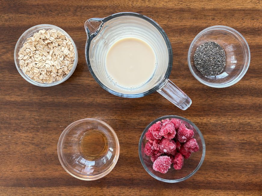 Top down view of small bowls with overnight oats ingredients