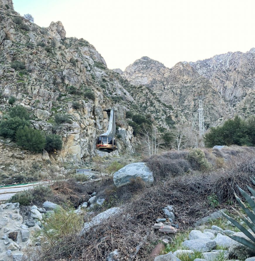 Aerial tramway car with rocky desert landscape