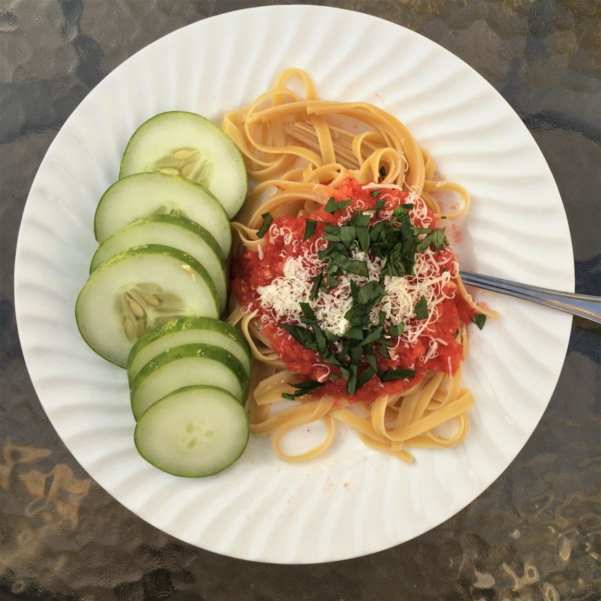 Plate of pasta with a fresh tomato sauce and sliced tomatoes
