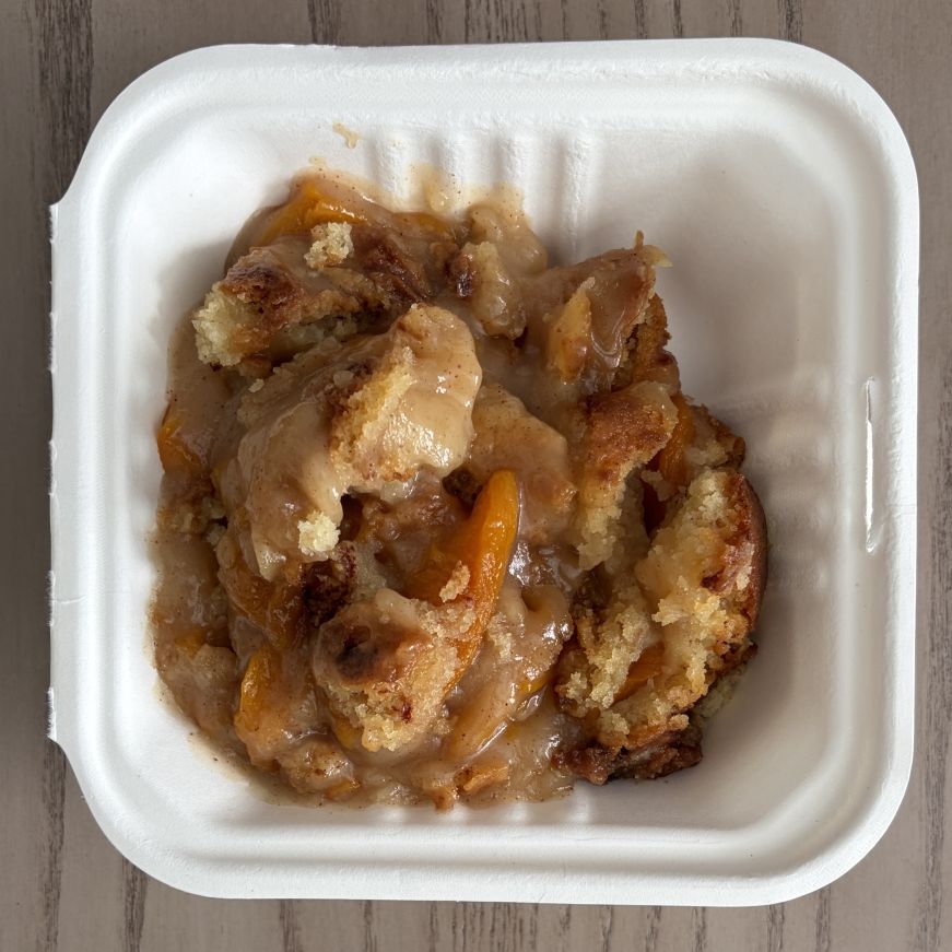 Peach cobbler in a takeout container