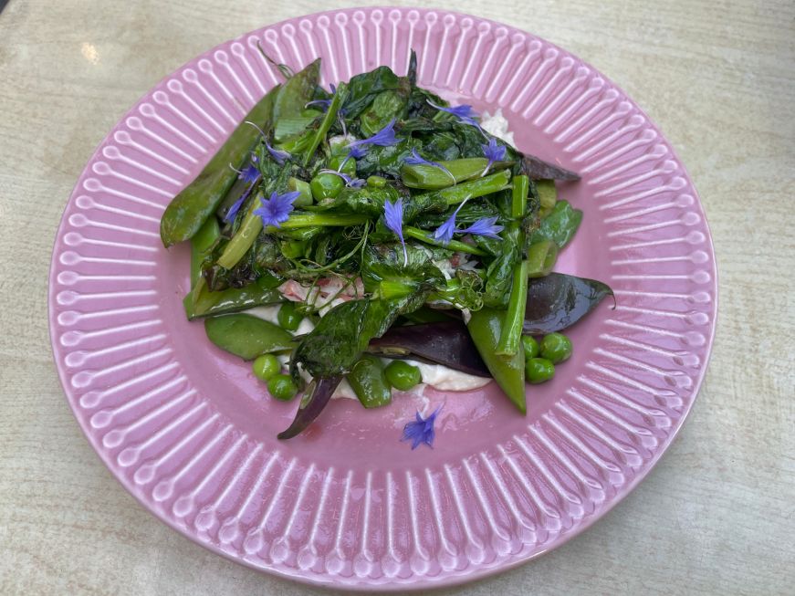 Ricotta, crab meat, and peas on a pink plate