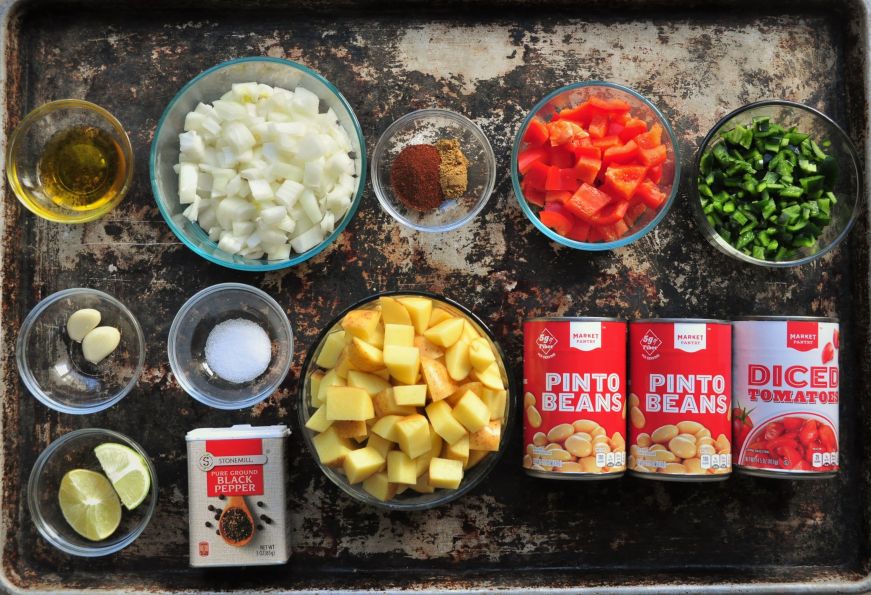 Ingredients for Peruvian potato bean stew arranged on baking sheet