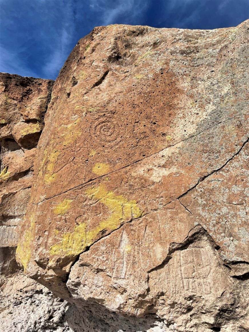 Petroglyphs on a brown cliff