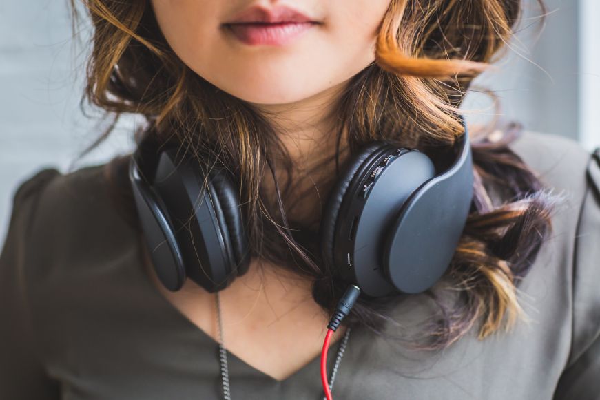 Woman wearing headphones around her neck