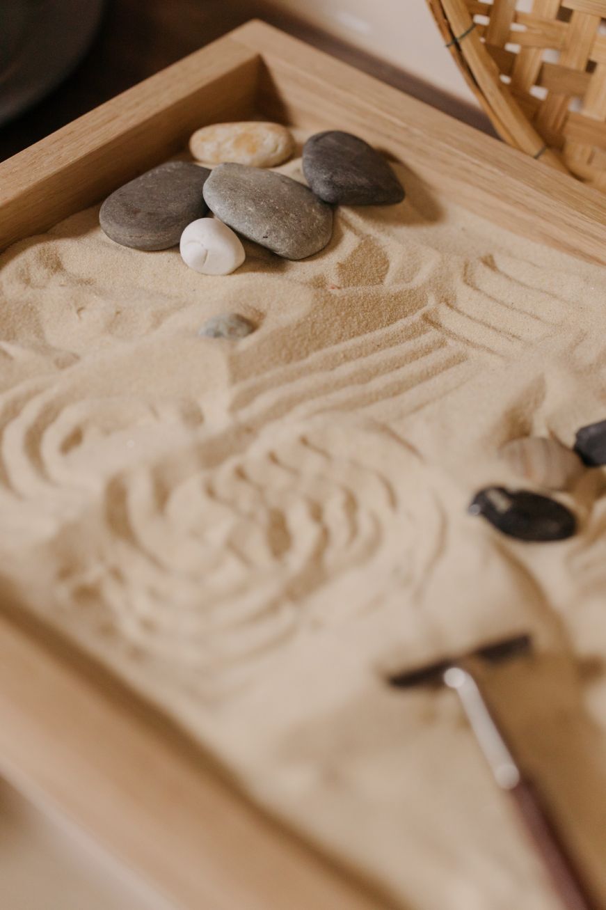 Tabletop Zen garden with raked sand and smooth polished stones